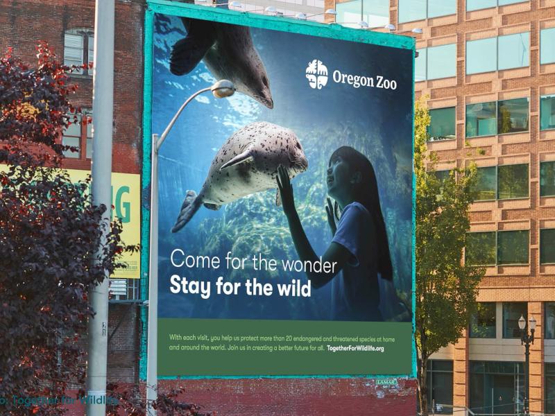 An Oregon Zoo billboard that says Come for the wonder, Stay for the wild