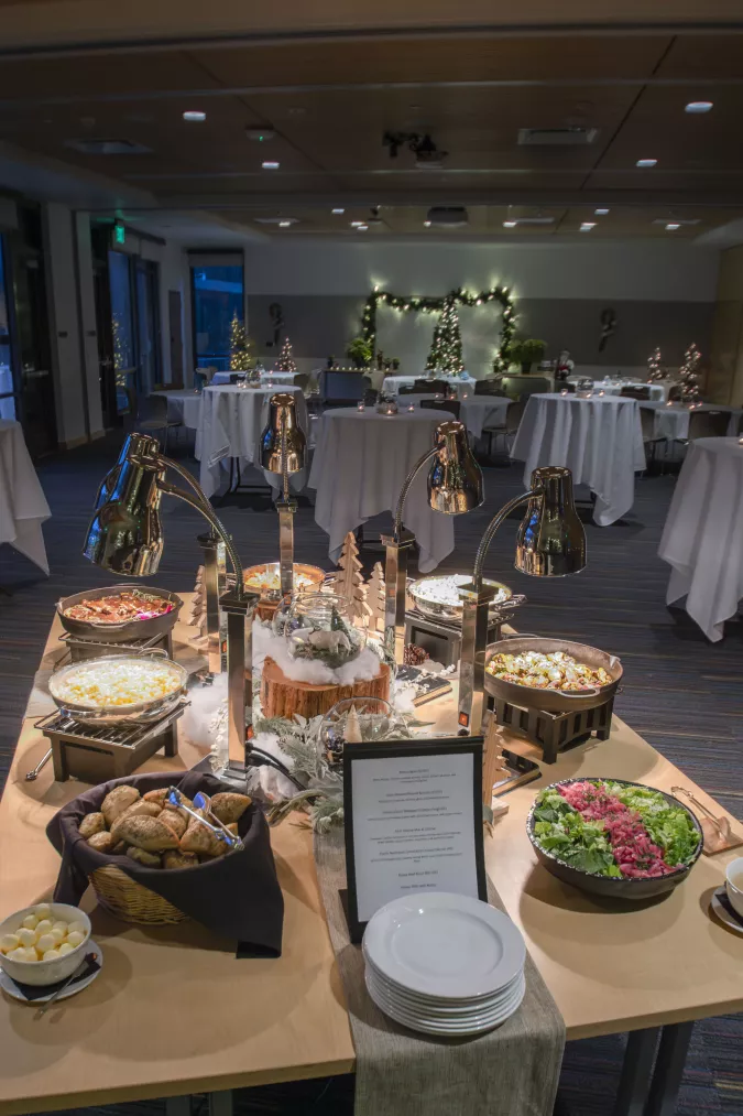 private holiday setup in hall with catering table in foreground